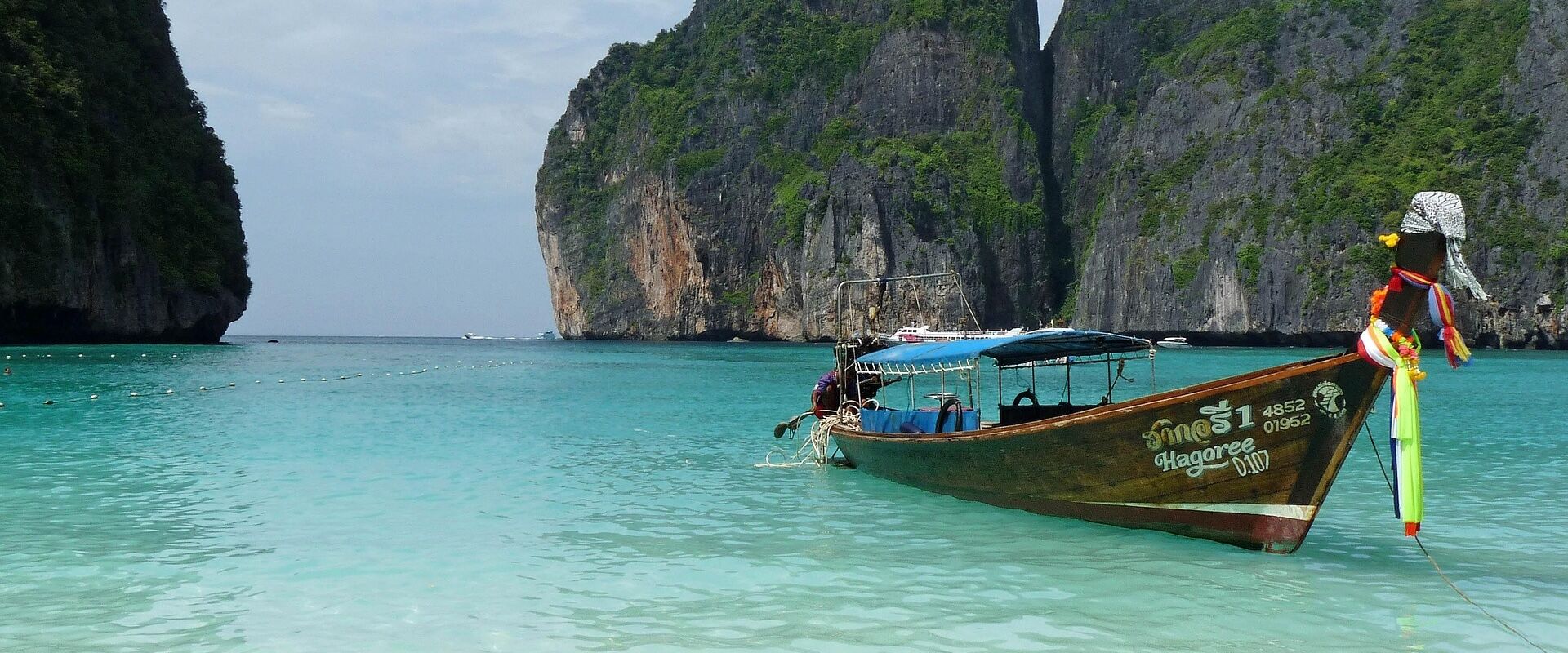 Phuket’s lush island landscape in Thailand on a Phuket Travel banner by Legend Travel Group.